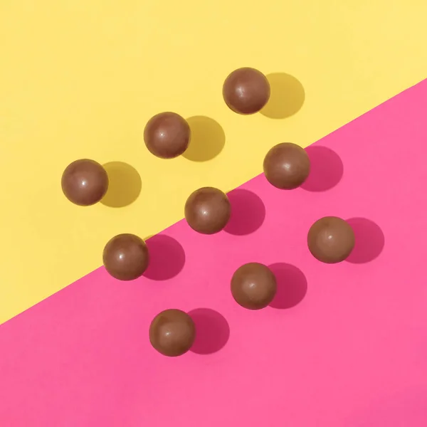 Chocolate Candy Balls Sunny Day Shadows Vibrant Pink Yellow Background — Foto de Stock