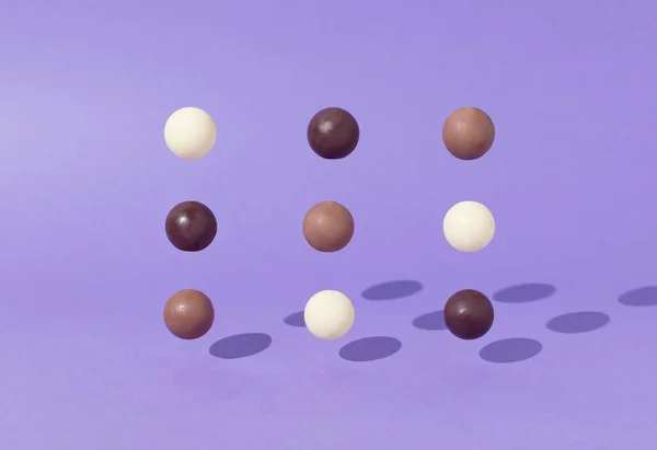 Creative Colorful Chocolate Balls Composition Purple Background Minimal Dessert Food — стоковое фото