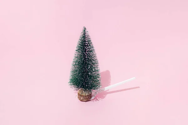 一棵圣诞和新年的树 雪白的塑料叉子上 粉红的背景 最小的设计 复制空间 — 图库照片