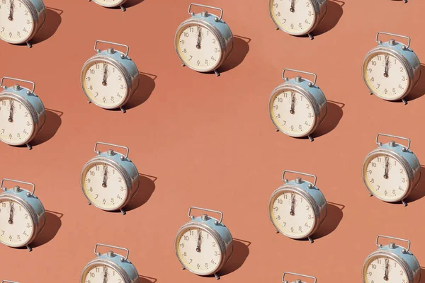 Arranged old retro silver clock on brown pastel background. Copy space.