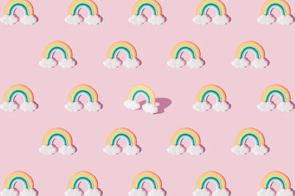 Small colorful rainbow with clouds. Pattern.