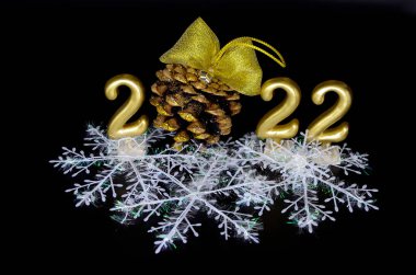 2022 numara altın rengi ve altın yaylı bir koni. Noel kavramı, yeni yıl.