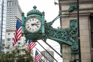 Şikago, ABD 'de bir sokakta barok süslemeli bir saat ve Amerikan bayrakları