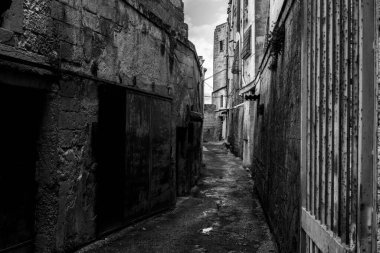 An empty path with old derelict houses in the center of Gargano, Southern Italy
