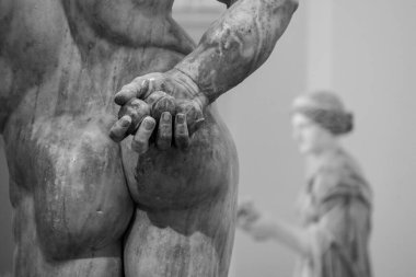 Close view of the butt of a ancient Roman statue hiding stones in his hand, Southern Italy