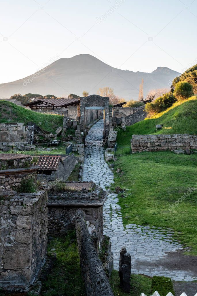 Early morning, a road leading to the ancient city remains of Pompeii, Mount Vesuvius in the background, Southern Italy