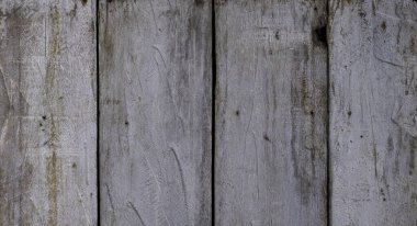 Vertical old weathered wood planks with distressed hammer markings and stain