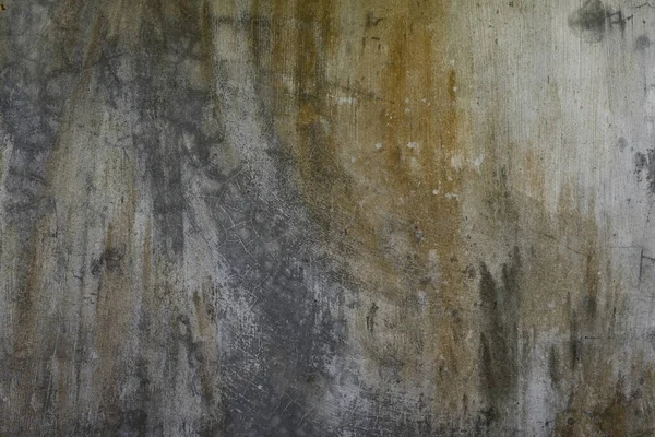 Dirty cream color cement wall with rust color smudges and background texture