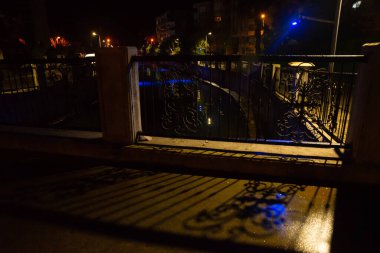 MARMARIS, MUGLA, TURKEY: Beautiful openwork decorative fence at the canal bridge in the city center with blue illumination at night in Marmaris.