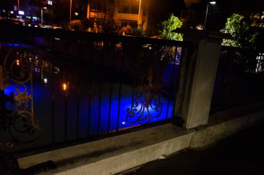 MARMARIS, MUGLA, TURKEY: Beautiful openwork decorative fence at the canal bridge in the city center with blue illumination at night in Marmaris.
