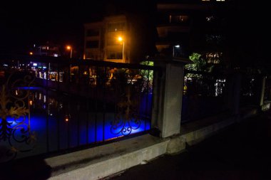 MARMARIS, MUGLA, TURKEY: Beautiful openwork decorative fence at the canal bridge in the city center with blue illumination at night in Marmaris.