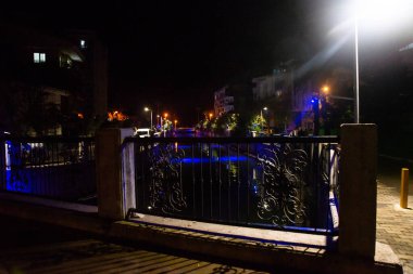 MARMARIS, MUGLA, TURKEY: Beautiful openwork decorative fence at the canal bridge in the city center with blue illumination at night in Marmaris.