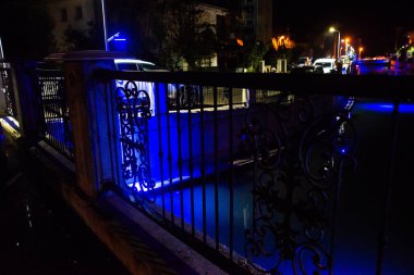 MARMARIS, MUGLA, TURKEY: Beautiful openwork decorative fence at the canal bridge in the city center with blue illumination at night in Marmaris.