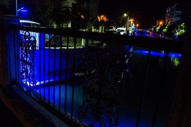 MARMARIS, MUGLA, TURKEY: Beautiful openwork decorative fence at the canal bridge in the city center with blue illumination at night in Marmaris.