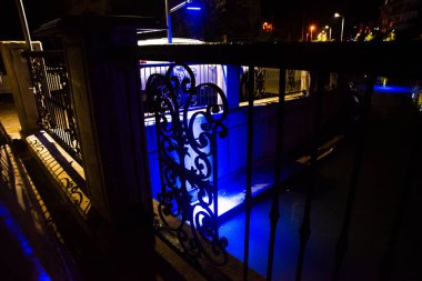 MARMARIS, MUGLA, TURKEY: Beautiful openwork decorative fence at the canal bridge in the city center with blue illumination at night in Marmaris.