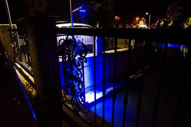 MARMARIS, MUGLA, TURKEY: Beautiful openwork decorative fence at the canal bridge in the city center with blue illumination at night in Marmaris.
