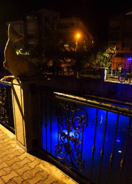 MARMARIS, MUGLA, TURKEY: Sculpture of a Fish on the street by the canal in Marmaris at night.