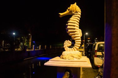MARMARIS, MUGLA, TURKEY: Sculpture of a Seahorse on the street by the canal in Marmaris at night.