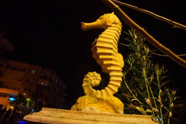 MARMARIS, MUGLA, TURKEY: Sculpture of a Seahorse on the street by the canal in Marmaris at night.