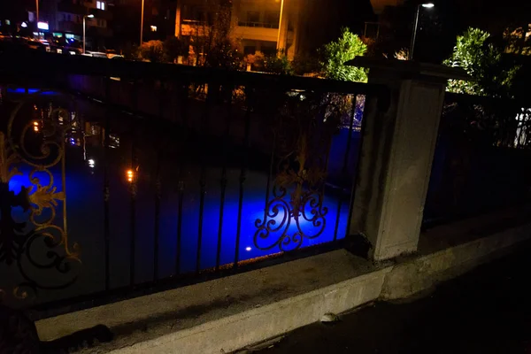 MARMARIS, MUGLA, TURKEY: Beautiful openwork decorative fence at the canal bridge in the city center with blue illumination at night in Marmaris.