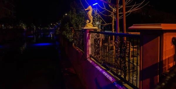 MARMARIS, MUGLA, TURKEY: Sculpture of a Seahorse on the street by the canal in Marmaris at night.