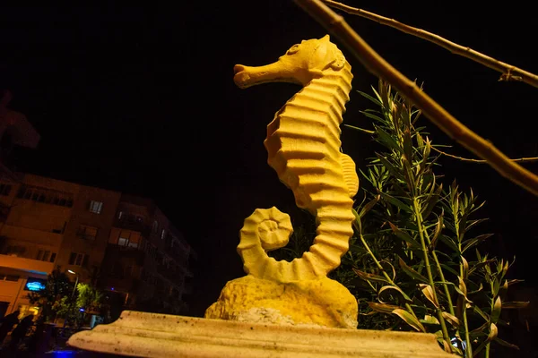 MARMARIS, MUGLA, TURKEY: Sculpture of a Seahorse on the street by the canal in Marmaris at night.