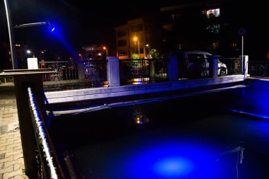 MARMARIS, MUGLA, TURKEY: Beautiful openwork decorative fence at the canal bridge in the city center with blue illumination at night in Marmaris.