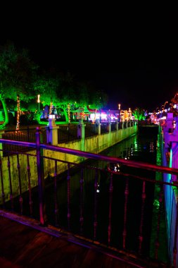 MARMARIS, MUGLA, TURKEY: View of the Canal with Fish sculptures and the New Year's fair at night in Marmaris.