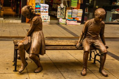MARMARIS, MUGLA, TURKEY: A modern monument of a girl and a boy on a bench on the street in Marmaris.