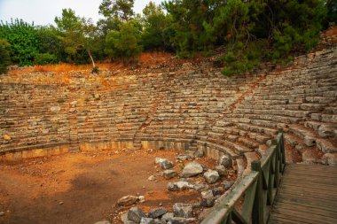 PHASELIS, KEMER, TURKEY: Ruins of the amphitheatre of the ancient city on a cloudy day of Phaselis in Turkey, Antalya province, near Kemer.