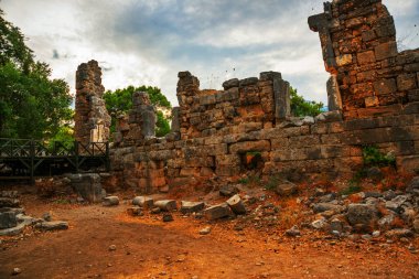 PHASELIS, KEMER, TURKEY: Ruins of the amphitheatre of the ancient city on a cloudy day of Phaselis in Turkey, Antalya province, near Kemer. clipart