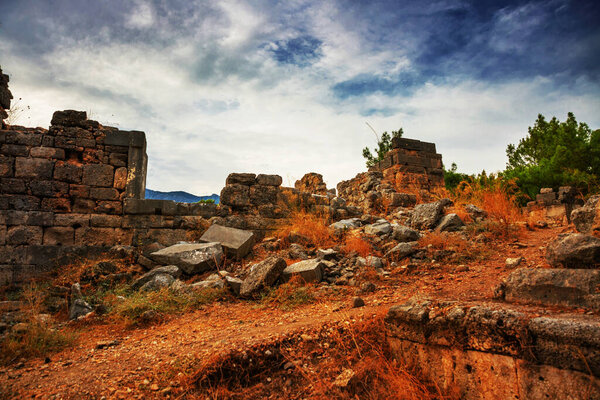 PHASELIS, KEMER, TURKEY: Ruins of the amphitheatre of the ancient city on a cloudy day of Phaselis in Turkey, Antalya province, near Kemer.