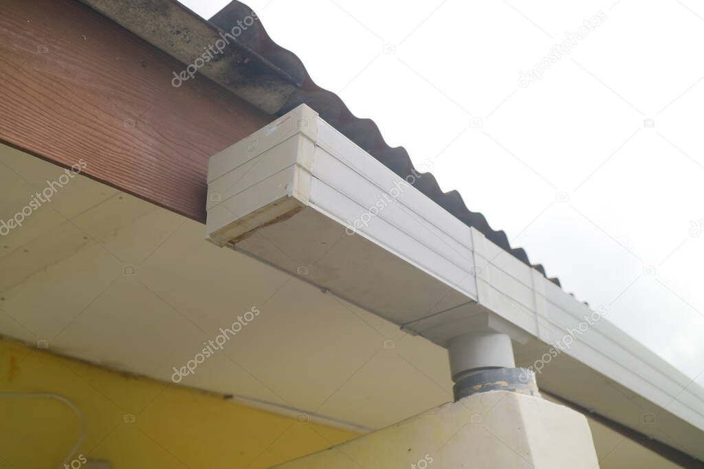 plastic gutter above the house photo