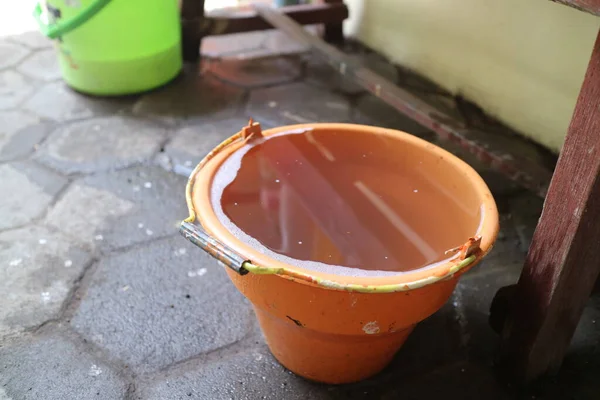 orange bucket full of water photo