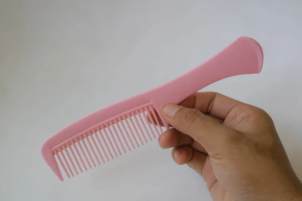 Hand Holding Pink Comb Photo — ストック写真