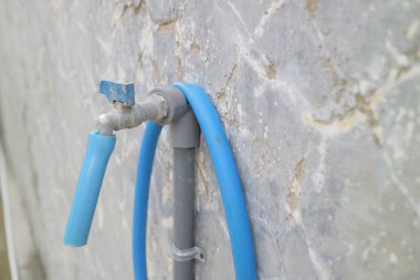 Semarang Indonesia november 22 2021: a photo of water faucet and hose in front of the house, taken in semarang city central java Indonesia