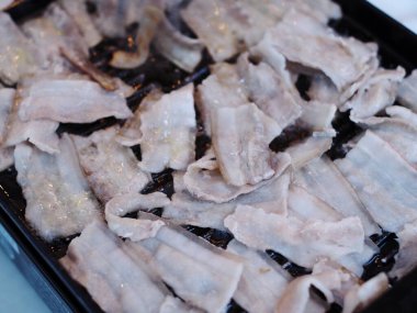 fresh delicious but unhealthy grilled pork on charcoal grill at rural outdoor stove authentic shot.