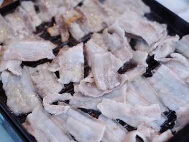 fresh delicious but unhealthy grilled pork on charcoal grill at rural outdoor stove authentic shot.