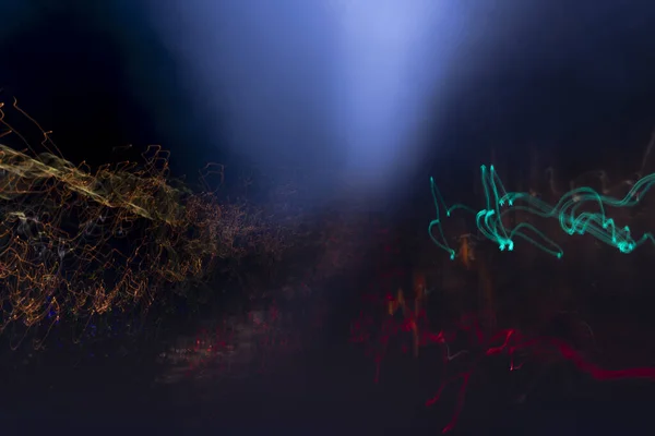 fantasia di luci colorate, fotografia notturna con soggetto una strada cittadina ripresa dall'auto in corsa