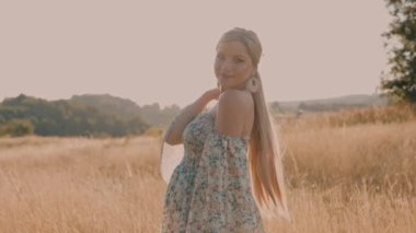 4k slow motion portrait of beautiful happy pregnant woman in countryside during sunset