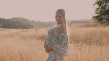 4k slow motion portrait of beautiful happy pregnant woman in countryside during sunset