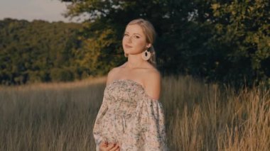 4k slow motion portrait of beautiful happy pregnant woman in countryside during sunset