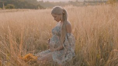 4k slow motion portrait of beautiful happy pregnant woman in countryside during sunset
