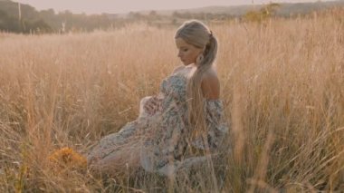 4k slow motion portrait of beautiful happy pregnant woman in countryside during sunset