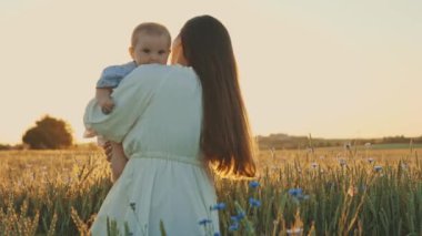 4k slow motion shot of mother and daughter having a picnic outdoors in the field. Playing and having fun with little baby . Happy family concept