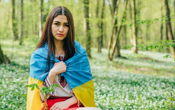 portrait of young beautiful Ukrainian woman in vyshyvanka - ukrainian national clothes. Stand with Ukraine