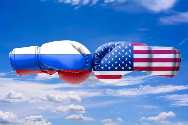3D illustration flags of Russia and USA on blue cloudy sky background.