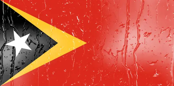 水滴背景玻璃上的东帝汶3D国旗 — 图库照片