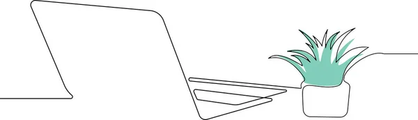 Laptop yeşil çiçekli masada.