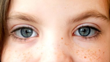 Close up of the little girl eyes opening and closing. Portrait shot. High quality photo